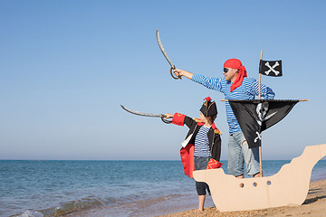 Image showing Father and son playing on the beach at the day time.