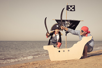 Image showing Father and son playing on the beach at the day time.