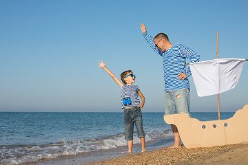 Image showing Father and son playing on the beach at the day time.