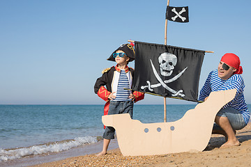 Image showing Father and son playing on the beach at the day time.