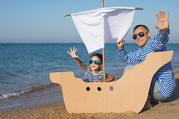 Image showing Father and son playing on the beach at the day time.