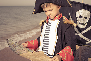 Image showing One happy little boy playing on the beach at the day time.