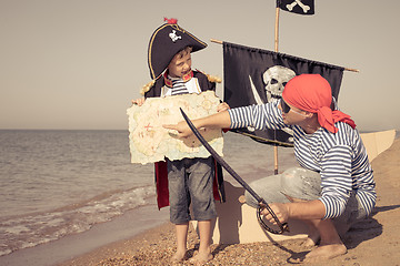 Image showing Father and son playing on the beach at the day time.