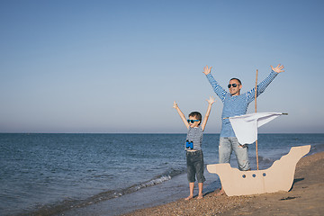 Image showing Father and son playing on the beach at the day time.