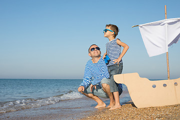 Image showing Father and son playing on the beach at the day time.