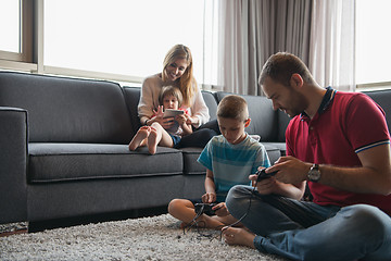 Image showing Happy family playing a video game