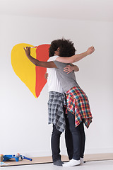 Image showing couple with painted heart on wall