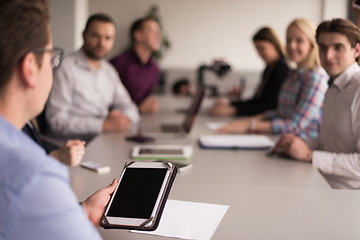 Image showing Businessman using tablet in modern office