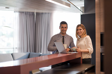 Image showing A young couple is preparing for a job and using a laptop