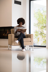 Image showing black woman at home reading book