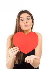 Image showing young woman in love with a heart in hand