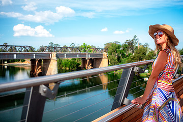 Image showing Carefree girl enjoying the river views from the bridge at Penrith