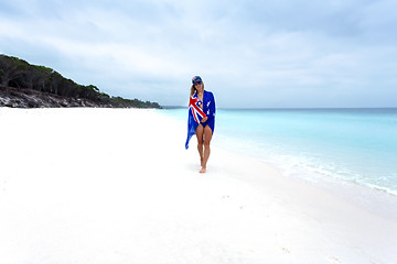 Image showing Woman on beach with Aussie flag draped around her