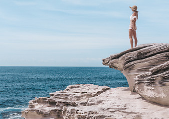 Image showing Fashion woman enjoying the summer sun by the coast