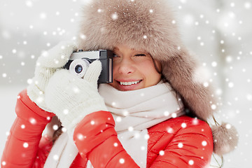 Image showing happy woman with film camera outdoors in winter