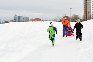 Image showing happy kids with sled having fun outdoors in winter