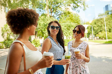 Image showing happy women or friends with drinks at summer park