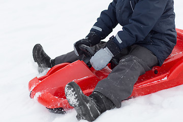 Image showing close up of boy driving sled in winter