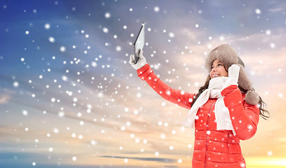 Image showing woman in winter fur hat with tablet pc outdoors