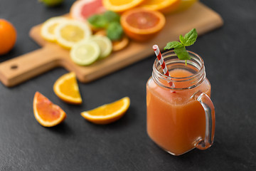 Image showing mason jar glass of fruit juice on slate table top