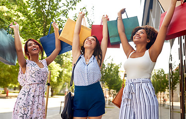 Image showing happy women with shopping bags in city