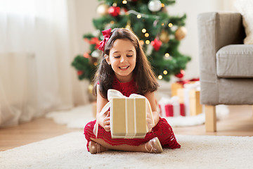 Image showing happy girl with christmas gift at home