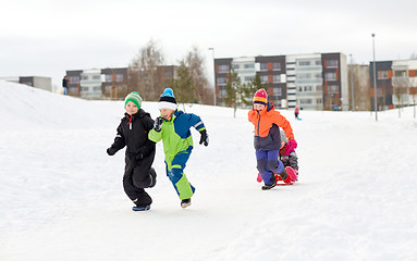 Image showing happy kids with sled having fun outdoors in winter