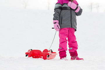 Image showing little girl with sled outdoors in winter