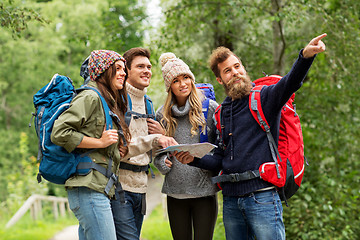 Image showing friends or travelers hiking with backpacks and map