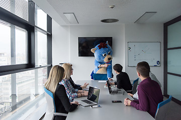 Image showing boss dresed as bear having fun with business people in trendy of