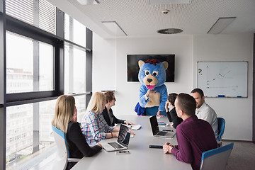 Image showing boss dresed as bear having fun with business people in trendy of