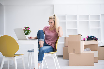 Image showing Young woman moving in a new home