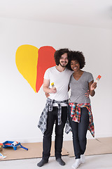 Image showing couple with painted heart on wall