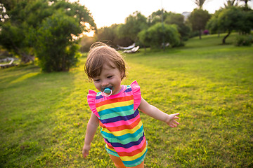 Image showing little girl spending time at backyard