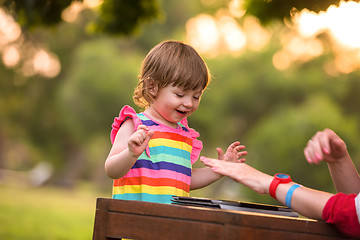 Image showing mom and her little daughter using tablet computer