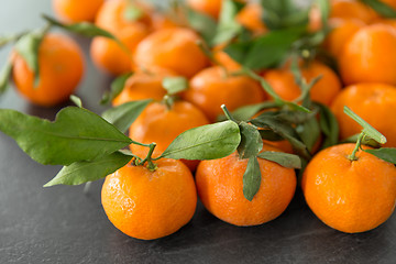 Image showing close up of mandarins on slate table top