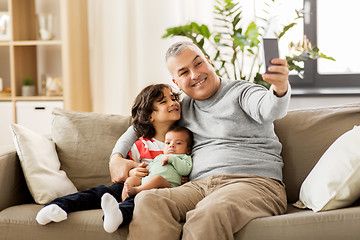 Image showing happy father with sons taking selfie at home