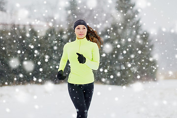 Image showing happy woman running outdoors in winter