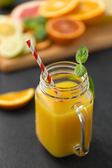 Image showing mason jar glass of fruit juice on slate table top