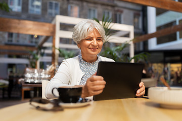 Image showing senior woman with tablet pc and coffee at cafe