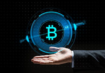 Image showing buisnessman hand with bitcoin hologram