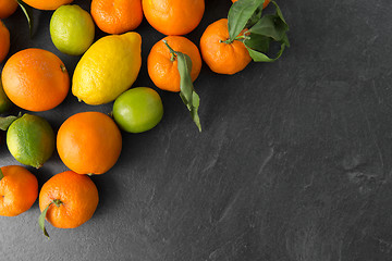 Image showing close up of citrus fruits on stone table