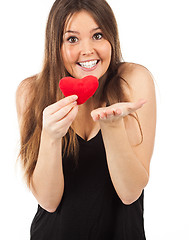 Image showing young woman in love with a heart in hand