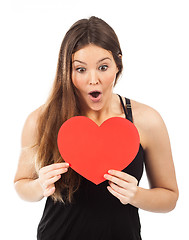 Image showing young woman in love with a heart in hand