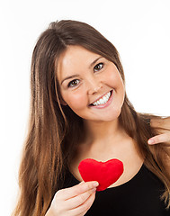 Image showing young woman in love with a heart in hand