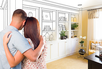 Image showing Young Military Couple Facing Custom Built-in Shelves and Cabinet