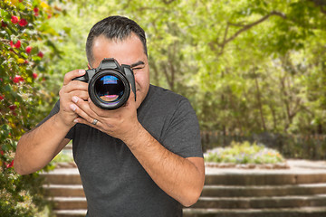 Image showing Hispanic Young Male Photographer With DSLR Camera Outdoors