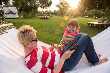 Image showing mom and a little daughter relaxing in a hammock