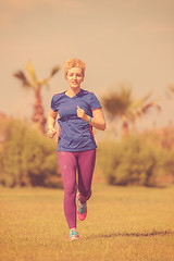 Image showing young female runner training for marathon