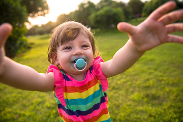 Image showing little girl spending time at backyard